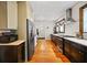 Galley style kitchen features dark cabinets, stainless steel appliances, and a window with natural light at 563 Ralph Mcgill Ne Blvd, Atlanta, GA 30312
