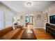 Cozy living room with hardwood floors, a large leather sofa, decorative lighting, and an open floor plan at 563 Ralph Mcgill Ne Blvd, Atlanta, GA 30312