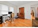 Bright office space features hardwood floors, a desk with computer, and a stylish wooden dresser at 563 Ralph Mcgill Ne Blvd, Atlanta, GA 30312