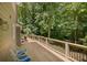 Outdoor deck featuring wood flooring, deck furniture, and views of the treeline at 1610 Old Mill Xing, Marietta, GA 30062