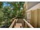 Inviting back deck with wooden railings, partially shaded by mature trees at 1610 Old Mill Xing, Marietta, GA 30062
