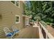 Outdoor deck featuring wood flooring, deck furniture, and views of the treeline at 1610 Old Mill Xing, Marietta, GA 30062