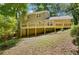 Back exterior view of the home with large deck and wooded lot at 1610 Old Mill Xing, Marietta, GA 30062