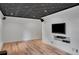 Finished basement featuring a drop ceiling, wood flooring, and a mounted television at 1610 Old Mill Xing, Marietta, GA 30062