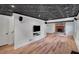 Finished basement with wood flooring, fireplace, drop ceiling, and mounted television at 1610 Old Mill Xing, Marietta, GA 30062