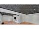 Finished basement featuring a drop ceiling, wood flooring, and a mounted television at 1610 Old Mill Xing, Marietta, GA 30062