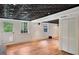 Finished basement featuring wood floors, ample light, closet, and a drop ceiling at 1610 Old Mill Xing, Marietta, GA 30062