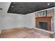 Finished basement with wood flooring and brick fireplace and mantle at 1610 Old Mill Xing, Marietta, GA 30062