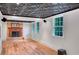 Spacious basement featuring wood floors, brick fireplace, and large windows for ample light at 1610 Old Mill Xing, Marietta, GA 30062