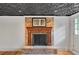 Finished basement with wood flooring and brick fireplace and mantle at 1610 Old Mill Xing, Marietta, GA 30062