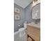 Powder room features a wood vanity, stylish mirror, and gray walls at 1610 Old Mill Xing, Marietta, GA 30062