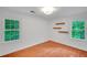 Sunlit bedroom with hardwood floors, bright windows, and minimalist floating shelves at 1610 Old Mill Xing, Marietta, GA 30062