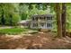 Traditional home featuring a well-maintained lawn, wood siding, blue shutters, and mature trees at 1610 Old Mill Xing, Marietta, GA 30062