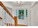 Bright foyer with hardwood floors, white trim, and a beautiful wood and white staircase at 1610 Old Mill Xing, Marietta, GA 30062