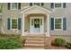 Inviting front porch featuring a blue door, brick steps, and classic white columns and shutters at 1610 Old Mill Xing, Marietta, GA 30062