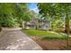 Charming two-story home with light beige siding, dark shutters, and a well-manicured front lawn with mature trees at 1610 Old Mill Xing, Marietta, GA 30062