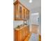 Hallway with wood floors and kitchen featuring wood cabinets, granite counters and stylish hardware at 1610 Old Mill Xing, Marietta, GA 30062