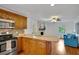 Modern kitchen with wooden cabinets, stainless steel appliances, and an island that opens to the living room at 1610 Old Mill Xing, Marietta, GA 30062