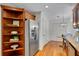 Kitchen with custom wood shelves, stainless refrigerator, light hardwood floors and breakfast nook at 1610 Old Mill Xing, Marietta, GA 30062