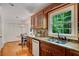 Kitchen sink and counter area features wood cabinetry, granite counters, tile backsplash and backyard views at 1610 Old Mill Xing, Marietta, GA 30062