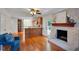 Open-concept living room with a brick fireplace, hardwood floors, and seamless kitchen access at 1610 Old Mill Xing, Marietta, GA 30062