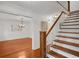 Elegant staircase with hardwood steps and white railings leading to the upper level at 1610 Old Mill Xing, Marietta, GA 30062