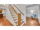 Elegant staircase with hardwood steps and white railings leading to a light filled sitting room at 1610 Old Mill Xing, Marietta, GA 30062