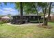 Backyard with a deck, manicured landscaping, gravel area and lush green grass at 1853 Pinedale Pl, Decatur, GA 30032
