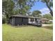 Exterior home view showing a modern deck and landscaping with green grass at 1853 Pinedale Pl, Decatur, GA 30032