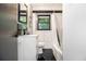 Clean bathroom featuring white tile walls, black tile floors, modern fixtures, and a shower/tub combination at 1853 Pinedale Pl, Decatur, GA 30032