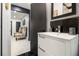 Bathroom featuring a modern vanity, updated fixtures, black accents, and an open doorway to the living area at 1853 Pinedale Pl, Decatur, GA 30032