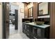 Modern bathroom with double bowl sinks, glass countertop, and black cabinets at 1853 Pinedale Pl, Decatur, GA 30032