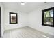 Bright and airy bedroom with two windows offering ample natural light, complemented by modern black trim at 1853 Pinedale Pl, Decatur, GA 30032