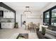 Cozy dining area adjacent to the modern kitchen featuring black beams and a light fixture, perfect for Gathering meals at 1853 Pinedale Pl, Decatur, GA 30032