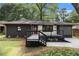 Charming renovated home with modern exterior, featuring a painted brick facade, new porch and stylish black and white accents at 1853 Pinedale Pl, Decatur, GA 30032