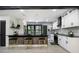 Modern kitchen featuring marble backsplash, breakfast bar, and open shelving, great for entertaining or casual dining at 1853 Pinedale Pl, Decatur, GA 30032