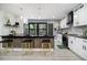Modern kitchen boasts stainless appliances, black countertops, white cabinets, and a breakfast bar with seating at 1853 Pinedale Pl, Decatur, GA 30032