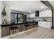 Modern kitchen boasts stainless appliances, black countertops, white cabinets, and a breakfast bar with seating at 1853 Pinedale Pl, Decatur, GA 30032