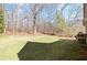 Expansive backyard with lush green lawn and mature trees, creating a private outdoor space at 4021 Melvin Sw Dr, Atlanta, GA 30331
