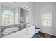Elegant bathroom with double vanity, granite countertops, and abundant natural light at 4021 Melvin Sw Dr, Atlanta, GA 30331