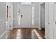 Inviting entryway with hardwood floors, white wainscoting, and a bright front door with sidelights at 4021 Melvin Sw Dr, Atlanta, GA 30331