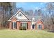 Charming brick and siding home with well-maintained lawn, mature trees, and a welcoming facade at 4021 Melvin Sw Dr, Atlanta, GA 30331