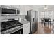 Modern kitchen with stainless steel appliances, granite countertops, and a bright breakfast nook at 4021 Melvin Sw Dr, Atlanta, GA 30331
