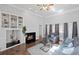 Cozy living room featuring a fireplace, built-in shelving, hardwood floors, and neutral décor at 4021 Melvin Sw Dr, Atlanta, GA 30331
