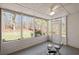 Relaxing sunroom with ceiling fan and multiple windows offering serene views of the wooded backyard at 4021 Melvin Sw Dr, Atlanta, GA 30331