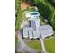 Aerial view showcases a home with a pool, manicured lawn, and a lengthy driveway, all embraced by verdant trees at 4095 N Broadland Nw Rd, Atlanta, GA 30342
