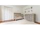 Cozy Bedroom with a plush rug, crib, dresser, and ample closet space at 4095 N Broadland Nw Rd, Atlanta, GA 30342