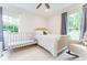 Bright bedroom with white crib, rocking chair, and natural light at 4095 N Broadland Nw Rd, Atlanta, GA 30342