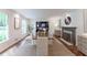 Bright dining room with a decorative fireplace, large windows, and stylish decor at 4095 N Broadland Nw Rd, Atlanta, GA 30342