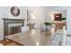 Elegant dining room with a large wooden table, white chairs, fireplace, and stylish décor at 4095 N Broadland Nw Rd, Atlanta, GA 30342